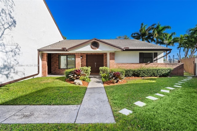 single story home with a front lawn