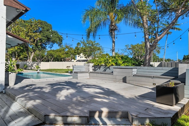 deck with a fenced in pool