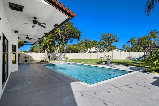 view of swimming pool with a yard, a patio, and a playground