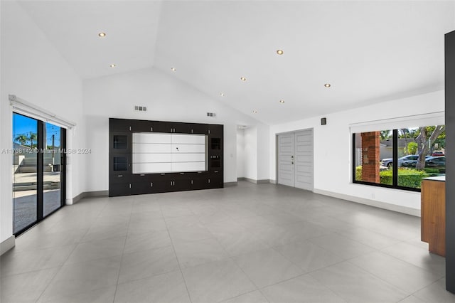 spare room featuring high vaulted ceiling