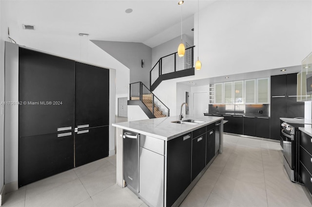 kitchen with pendant lighting, stainless steel electric stove, a spacious island, and sink