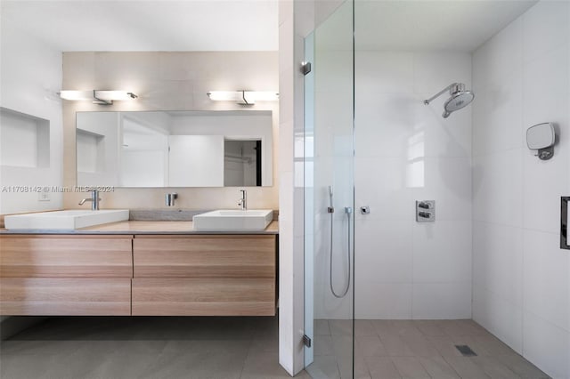 bathroom featuring vanity and a tile shower