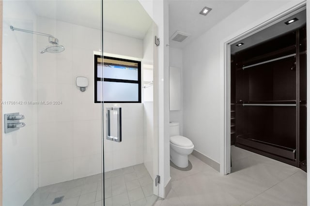 bathroom featuring walk in shower and toilet