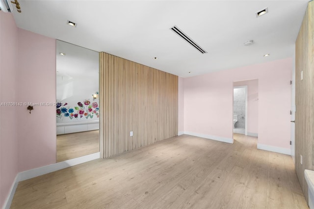 spare room featuring light wood-type flooring