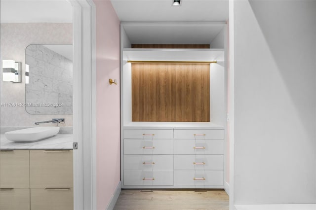 interior space with vanity and hardwood / wood-style flooring