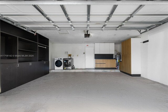 garage with washer and dryer and a garage door opener