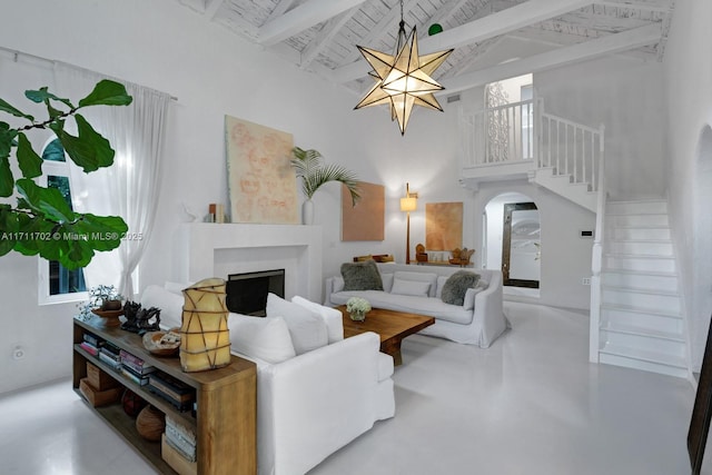 living room featuring beam ceiling, wood ceiling, an inviting chandelier, and high vaulted ceiling