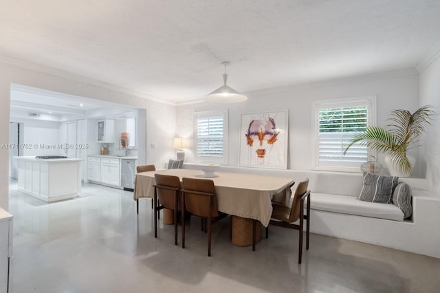 dining room with sink and ornamental molding