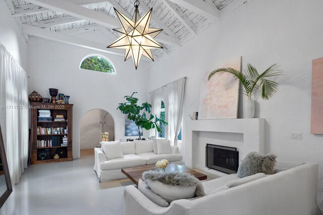 living room with concrete floors, wood ceiling, high vaulted ceiling, and beamed ceiling