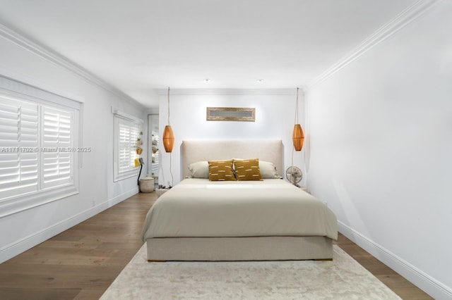 bedroom featuring crown molding and hardwood / wood-style flooring