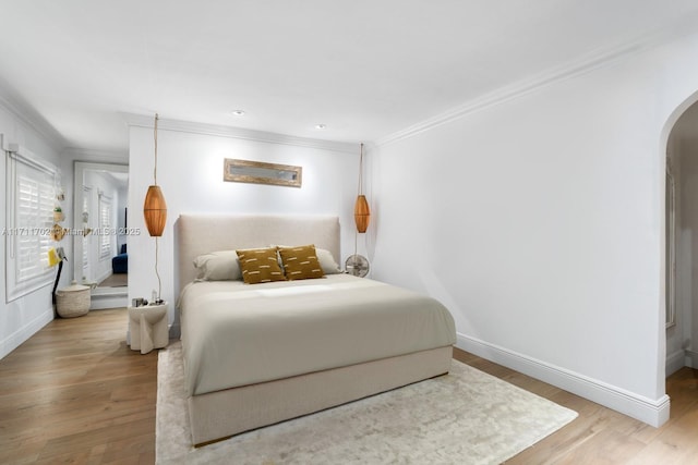 bedroom featuring hardwood / wood-style floors and crown molding