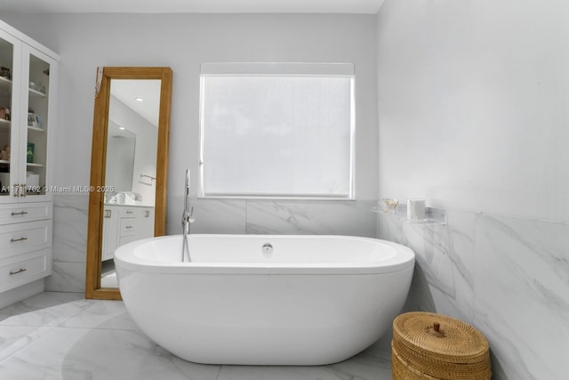 bathroom with vanity and a bathtub