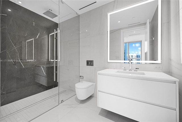 bathroom with tiled shower, vanity, tile walls, and toilet