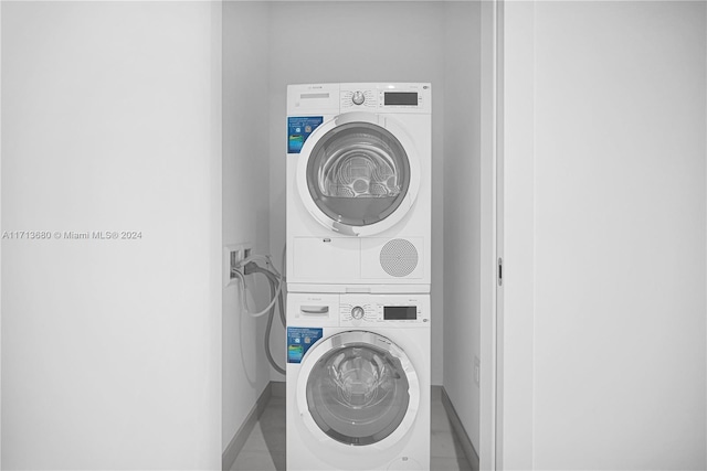 laundry area featuring stacked washer / drying machine