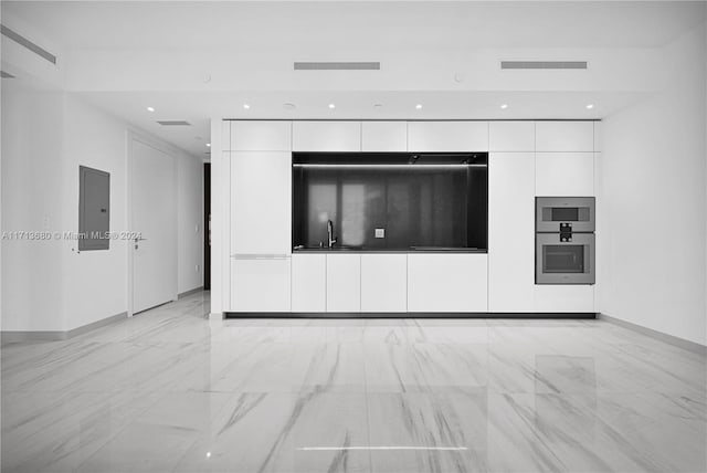 unfurnished living room with electric panel and sink