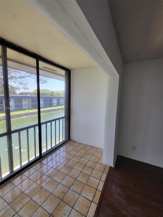 tiled empty room with a wall of windows