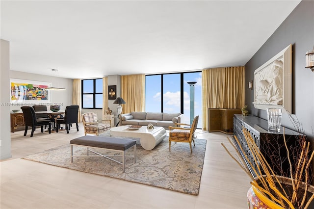 living room with floor to ceiling windows and hardwood / wood-style floors