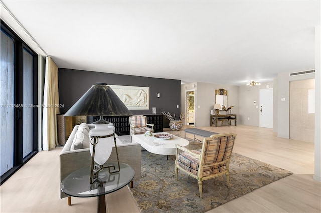 living room with light hardwood / wood-style floors and a wealth of natural light