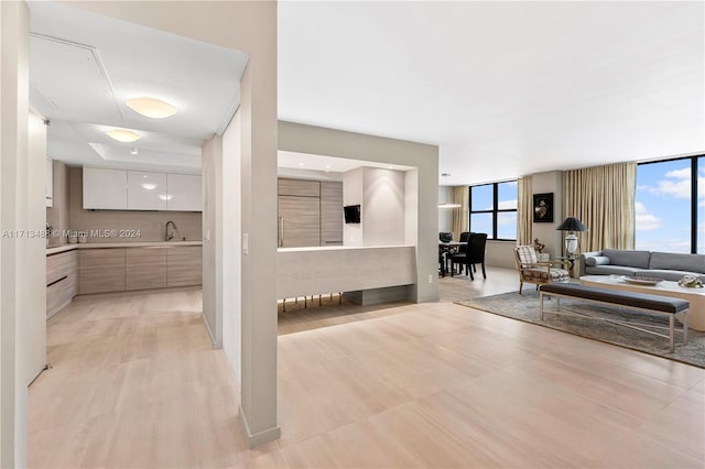 living room with sink and light wood-type flooring