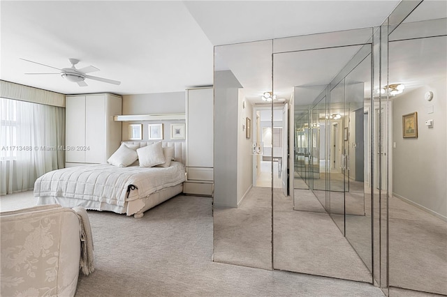 bedroom with ceiling fan, light carpet, and multiple windows