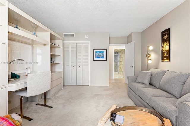 home office with light colored carpet and a textured ceiling