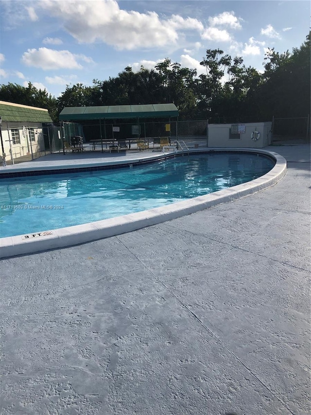 view of swimming pool with a patio area