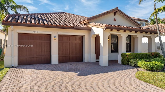 mediterranean / spanish house with a garage