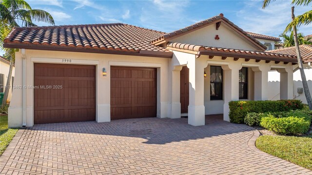 mediterranean / spanish-style house with a garage