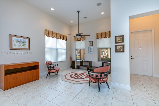 sitting room featuring light tile patterned floors and ceiling fan