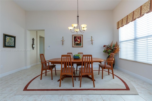 dining area with a wealth of natural light, light tile patterned floors, and a chandelier