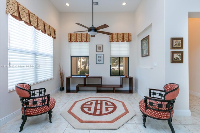 sitting room with ceiling fan and light tile patterned floors