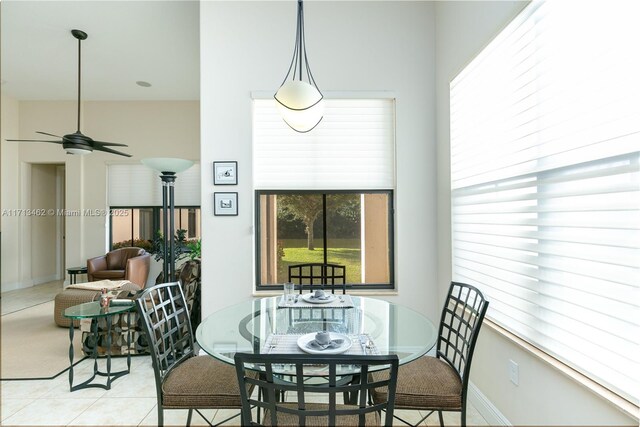 tiled dining room with ceiling fan and a healthy amount of sunlight