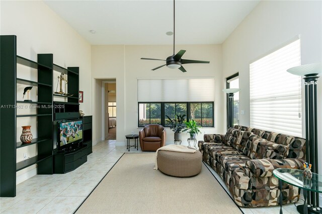 tiled living room featuring ceiling fan