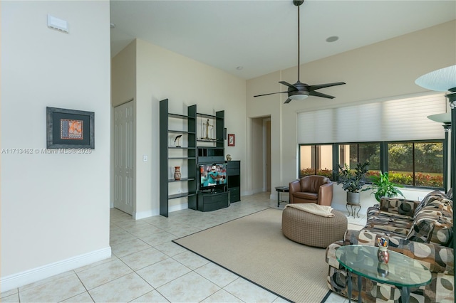 tiled living room with a towering ceiling and ceiling fan