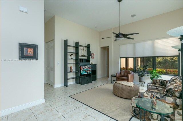 tiled living room featuring a towering ceiling and ceiling fan