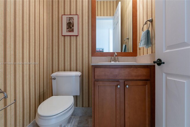 bathroom with vanity, tile patterned floors, and toilet