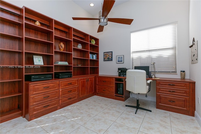 tiled home office with ceiling fan and vaulted ceiling