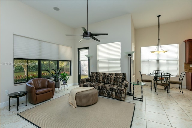 living room featuring vaulted ceiling, light tile patterned floors, and ceiling fan