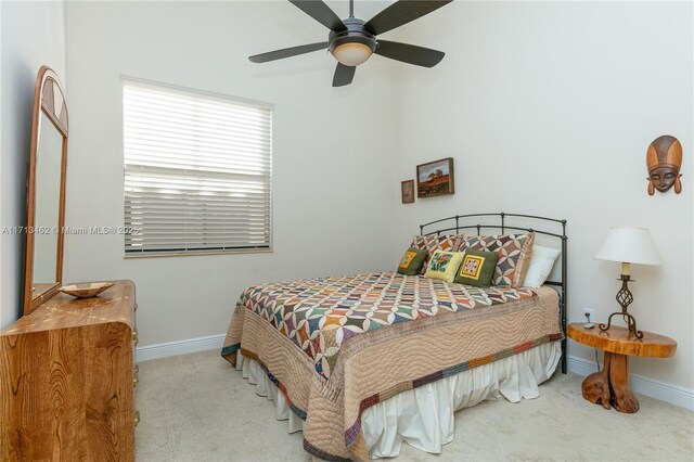 bedroom featuring light colored carpet and ceiling fan