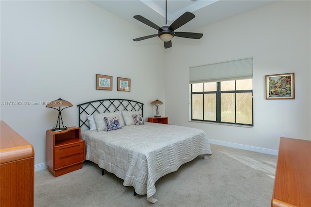 carpeted bedroom with high vaulted ceiling and ceiling fan