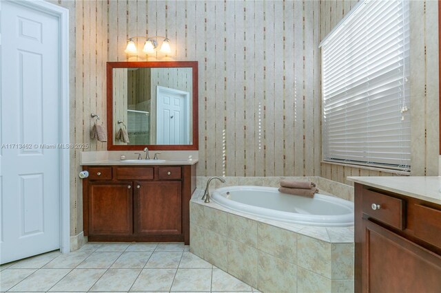 bathroom with plus walk in shower, tile patterned floors, and vanity