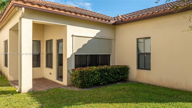 back of property with a patio and a lawn