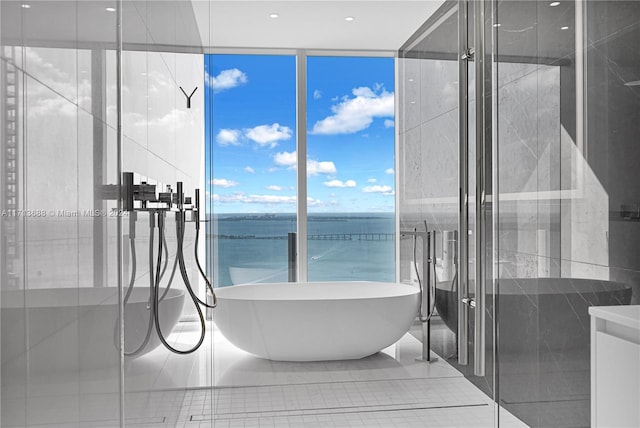 bathroom with plus walk in shower, a water view, and a wall of windows