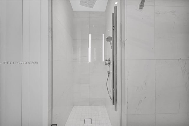 bathroom featuring a shower with door