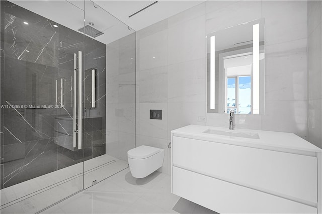 bathroom featuring a tile shower, vanity, tile walls, and toilet