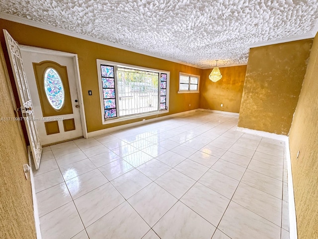 entryway featuring light tile patterned floors, a chandelier, and ornamental molding