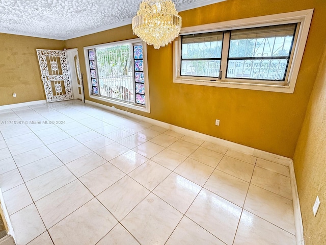 unfurnished room with crown molding, light tile patterned flooring, a textured ceiling, and a notable chandelier