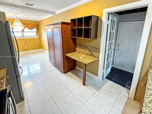 kitchen featuring stainless steel fridge, pendant lighting, stone countertops, light tile patterned floors, and ornamental molding