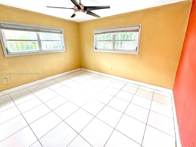 tiled empty room with ceiling fan