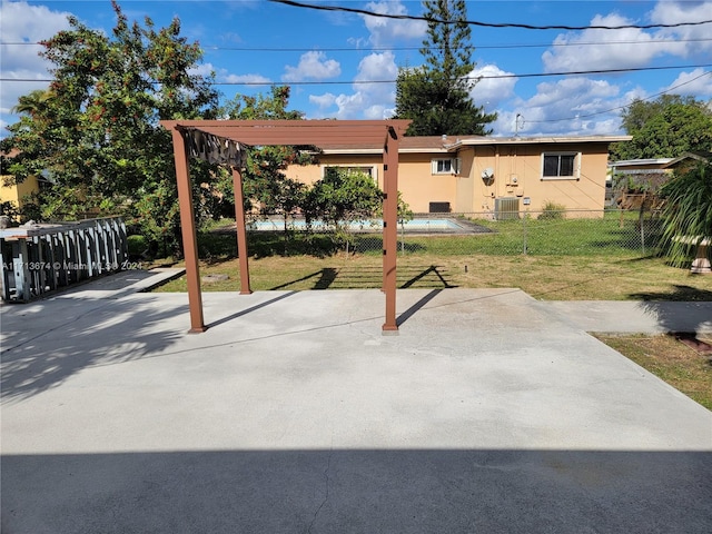 view of patio with a pool, a pergola, and central air condition unit